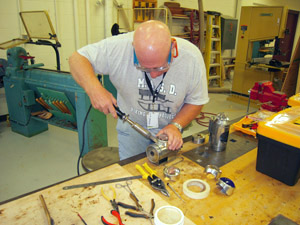Soldering lens cylinder to door.